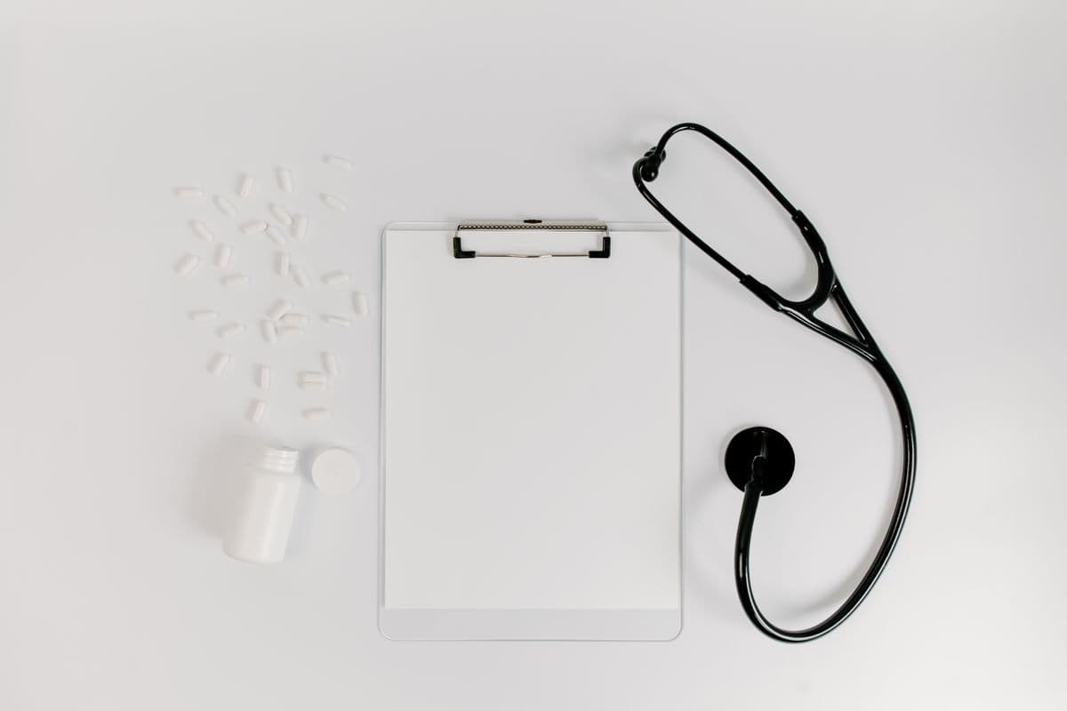 A stethoscope resting on medical paperwork