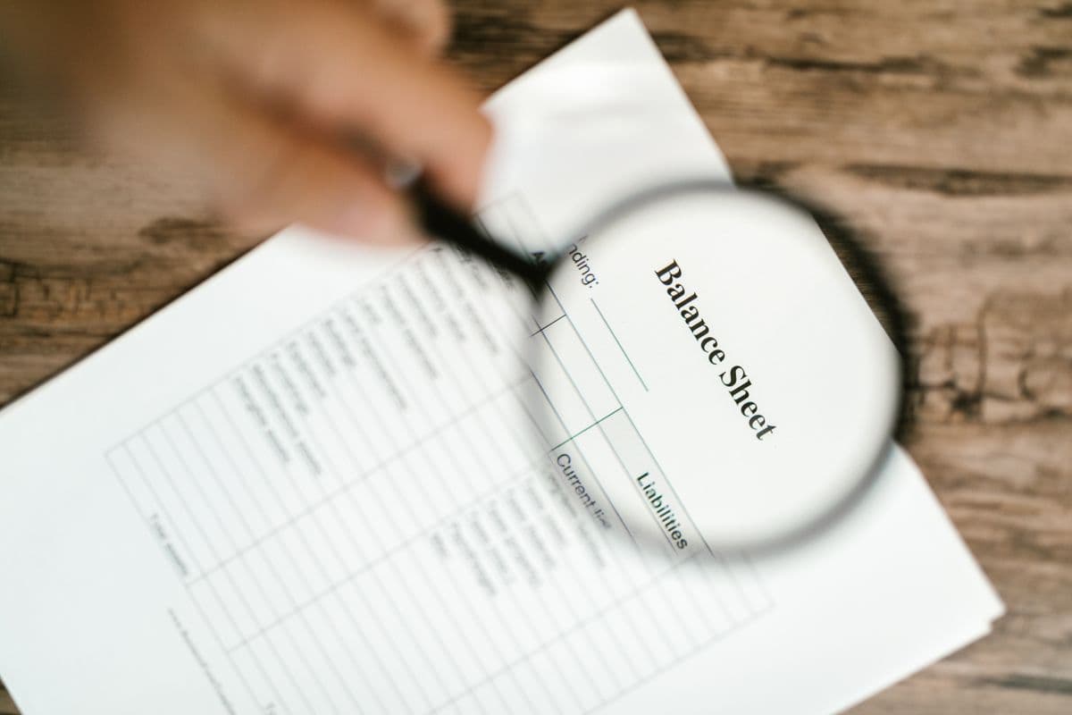 A magnifying glass over financial documents